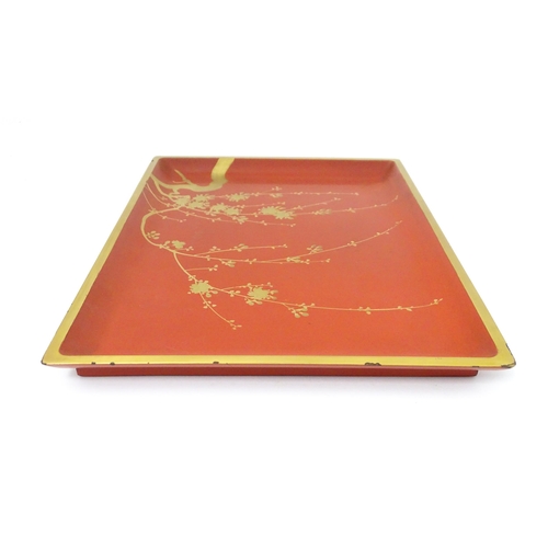 1045 - An Oriental Art Deco style red lacquer cocktail tray of rectangular form decorated with gilt blossom... 