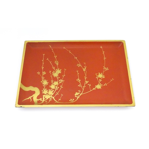 1045 - An Oriental Art Deco style red lacquer cocktail tray of rectangular form decorated with gilt blossom... 