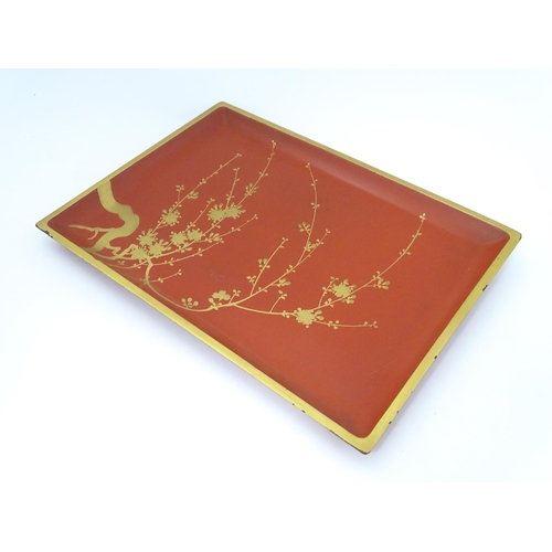 1045 - An Oriental Art Deco style red lacquer cocktail tray of rectangular form decorated with gilt blossom... 