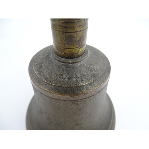 1050 - A 20thC hand bell with turned wooden handle, stamped WH to top to bell. Approx. 10 1/2