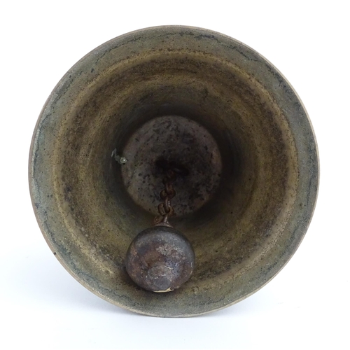 1050 - A 20thC hand bell with turned wooden handle, stamped WH to top to bell. Approx. 10 1/2