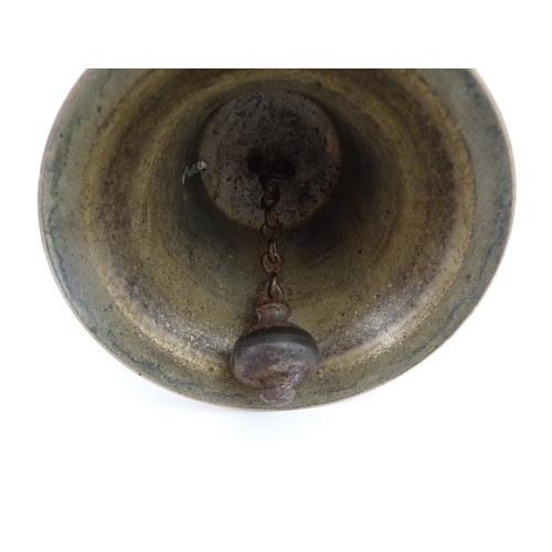 1050 - A 20thC hand bell with turned wooden handle, stamped WH to top to bell. Approx. 10 1/2