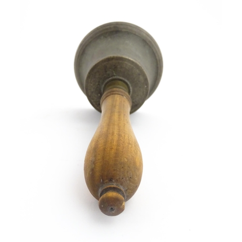 1050 - A 20thC hand bell with turned wooden handle, stamped WH to top to bell. Approx. 10 1/2