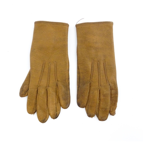 1080 - A pair of early 20thC childrens kid leather gloves. Together with a beadwork bag (2). Gloves approx.... 