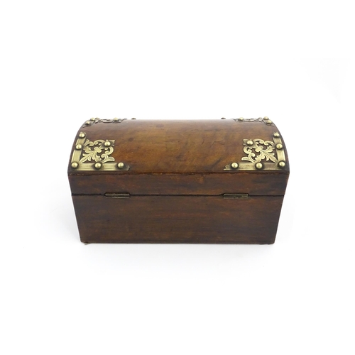 1086 - A 19thC walnut box, the dome top with applied brass mounts, opening to reveal a fitted interior and ... 