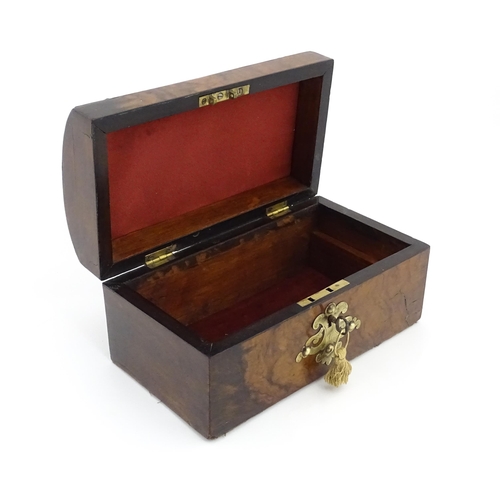 1086 - A 19thC walnut box, the dome top with applied brass mounts, opening to reveal a fitted interior and ... 