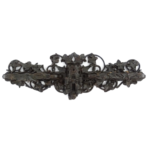 1196 - An early 20thC Black Forest pipe rack with provision for eight pipes, with carved castle and drawbri... 