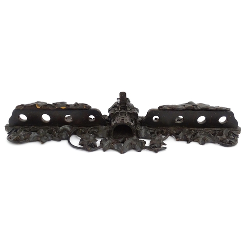 1196 - An early 20thC Black Forest pipe rack with provision for eight pipes, with carved castle and drawbri... 