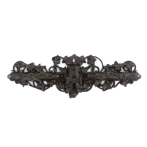 1196 - An early 20thC Black Forest pipe rack with provision for eight pipes, with carved castle and drawbri... 