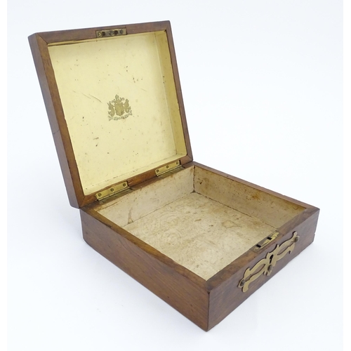 1206 - A 19thC walnut box of square form with applied gilt metal mounts. The interior of the lid bearing th... 