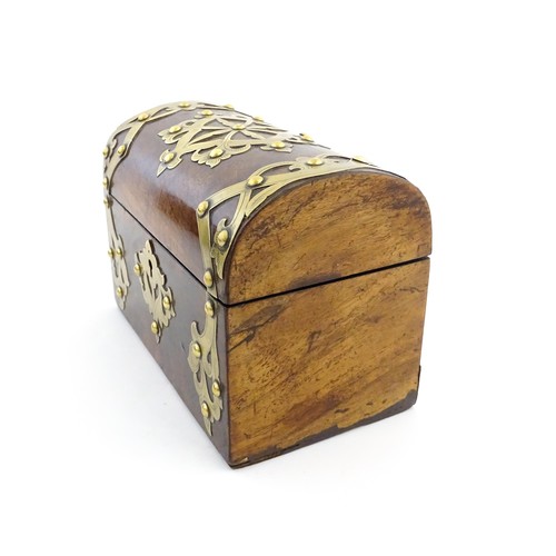 1211 - A 19thC walnut tea caddy of dome form with brass strapwork decoration and rivet detail, opening to r... 