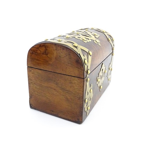 1211 - A 19thC walnut tea caddy of dome form with brass strapwork decoration and rivet detail, opening to r... 