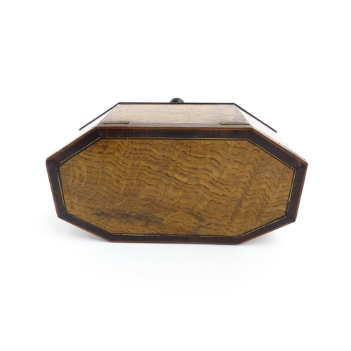 1220 - A 19thC tea caddy of octagonal form with crossbanded rosewood top raised on four feet, opening to re... 