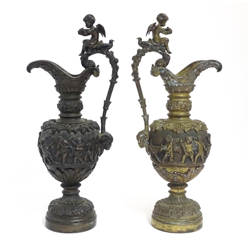 1230 - A pair of early 20thC cast ornamental ewers decorated in relief with fruiting vine and banded putti ... 