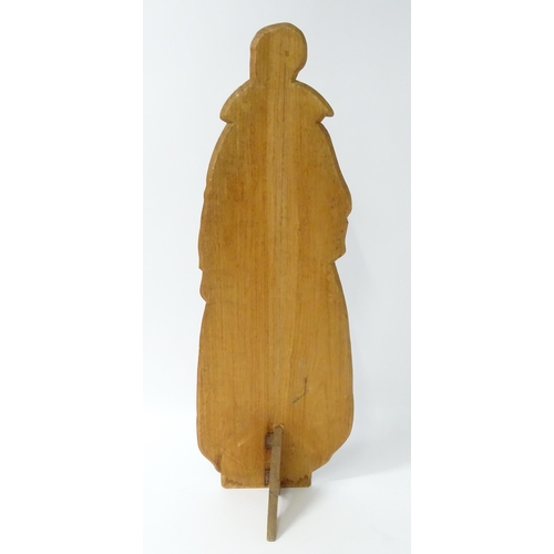 1267 - A large 20thC figural dummy board with hand painted decoration depicting a young lady holding a bask... 