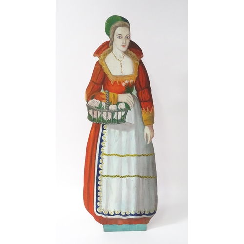 1267 - A large 20thC figural dummy board with hand painted decoration depicting a young lady holding a bask... 