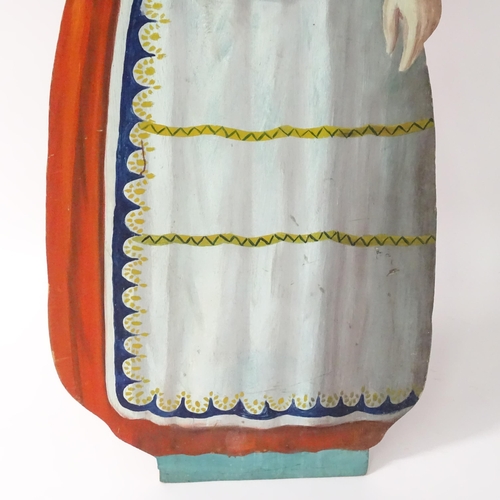 1267 - A large 20thC figural dummy board with hand painted decoration depicting a young lady holding a bask... 