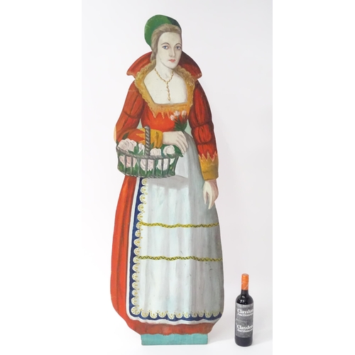 1267 - A large 20thC figural dummy board with hand painted decoration depicting a young lady holding a bask... 