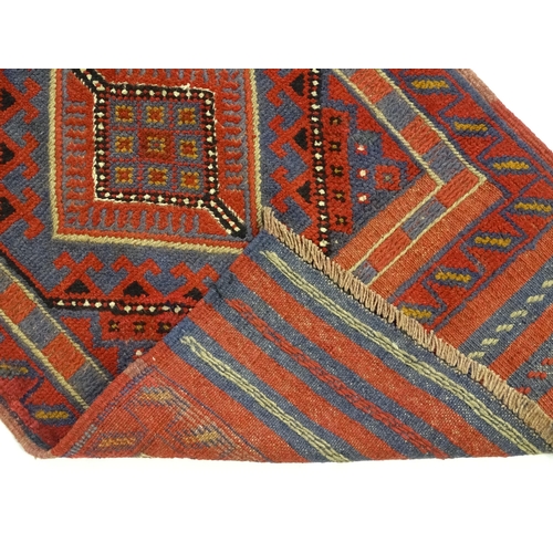 1352 - Carpet / Rug : A Meshwani runner  with red and blue ground having geometric detail. Approx.   105