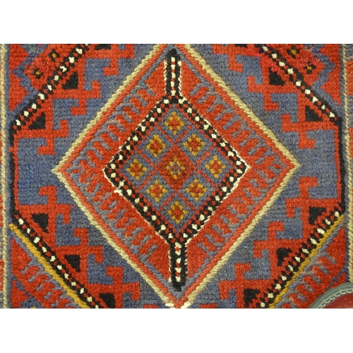 1352 - Carpet / Rug : A Meshwani runner  with red and blue ground having geometric detail. Approx.   105