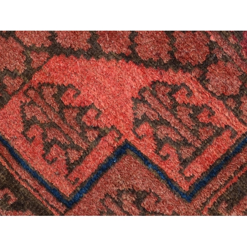 1355 - Carpet / Rug : A red ground rug with four central medallions decorated with geometric and foliate de... 