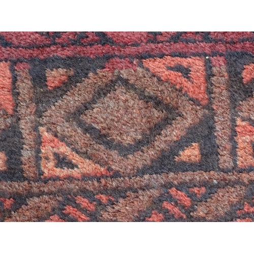 1355 - Carpet / Rug : A red ground rug with four central medallions decorated with geometric and foliate de... 