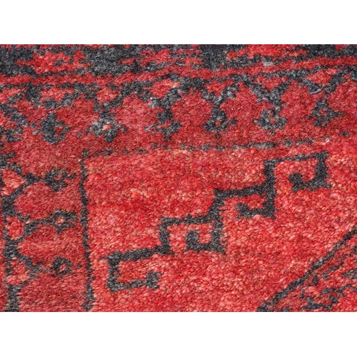 1362 - Carpet / Rug : A red ground rug with three central medallions decorated with geometric floral and fo... 