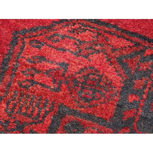 1362 - Carpet / Rug : A red ground rug with three central medallions decorated with geometric floral and fo... 