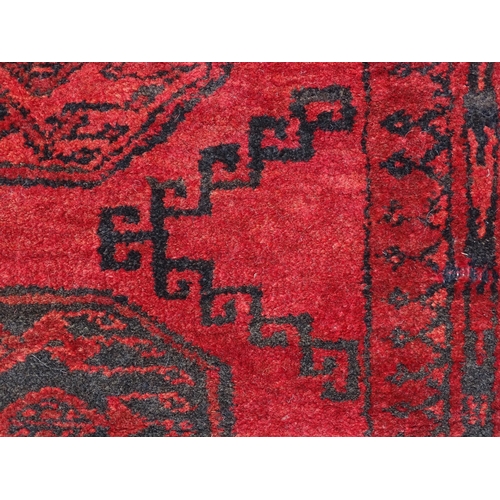 1362 - Carpet / Rug : A red ground rug with three central medallions decorated with geometric floral and fo... 