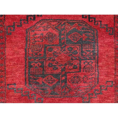 1362 - Carpet / Rug : A red ground rug with three central medallions decorated with geometric floral and fo... 