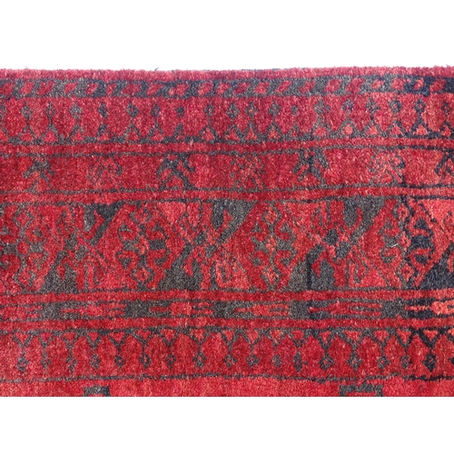 1362 - Carpet / Rug : A red ground rug with three central medallions decorated with geometric floral and fo... 