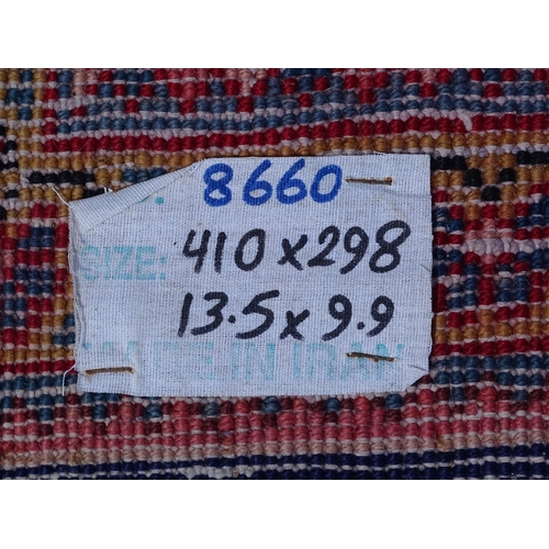 1368 - Carpet / Rug : A Persian rug the blue ground decorated with repeating floral motifs with central cre... 