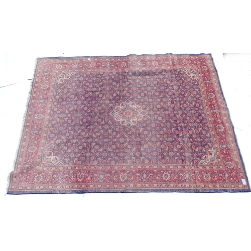 1368 - Carpet / Rug : A Persian rug the blue ground decorated with repeating floral motifs with central cre... 