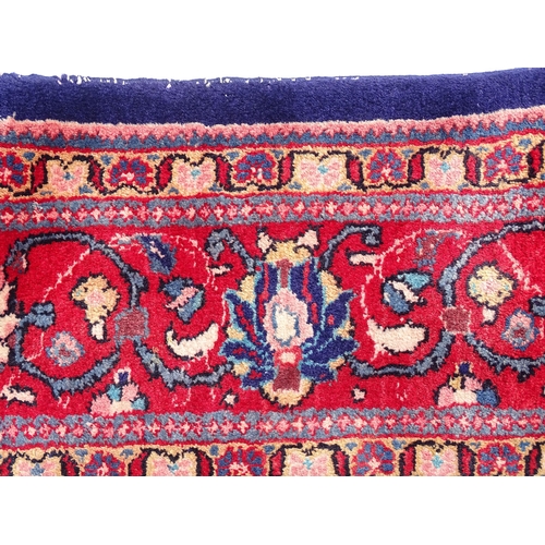 1368 - Carpet / Rug : A Persian rug the blue ground decorated with repeating floral motifs with central cre... 