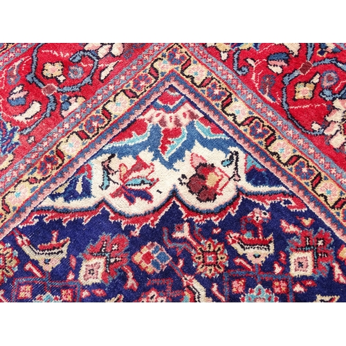 1368 - Carpet / Rug : A Persian rug the blue ground decorated with repeating floral motifs with central cre... 