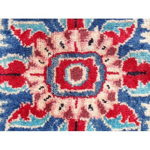 1368 - Carpet / Rug : A Persian rug the blue ground decorated with repeating floral motifs with central cre... 