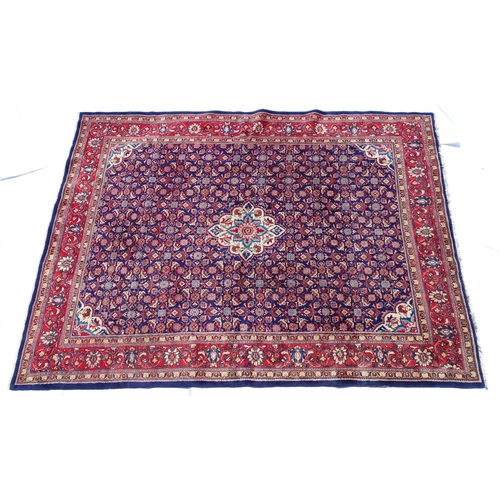 1368 - Carpet / Rug : A Persian rug the blue ground decorated with repeating floral motifs with central cre... 