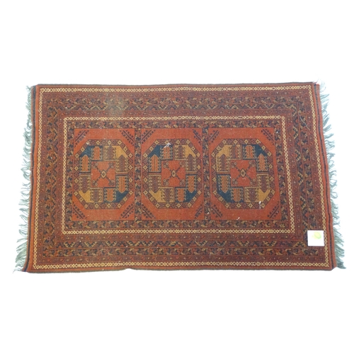 1379 - Carpet / Rug : A rug having orange red ground decorated with repeating geometric, floral and foliate... 