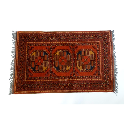 1379 - Carpet / Rug : A rug having orange red ground decorated with repeating geometric, floral and foliate... 