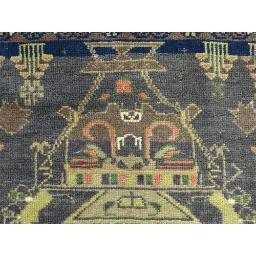 1382 - Carpet / Rug : A rug with dark ground decorated with two stylised vases bordered by floral, foliate ... 