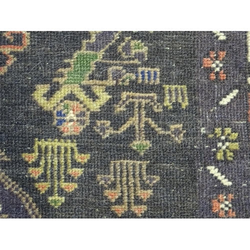 1382 - Carpet / Rug : A rug with dark ground decorated with two stylised vases bordered by floral, foliate ... 