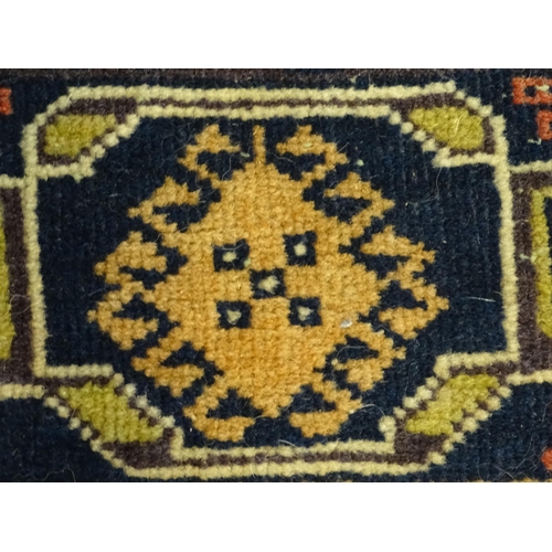 1382 - Carpet / Rug : A rug with dark ground decorated with two stylised vases bordered by floral, foliate ... 