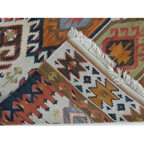 1384 - Carpet / Rug : A rug with cream ground decorated with repeating geometric detail. Approx.  73