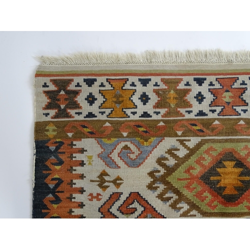 1384 - Carpet / Rug : A rug with cream ground decorated with repeating geometric detail. Approx.  73