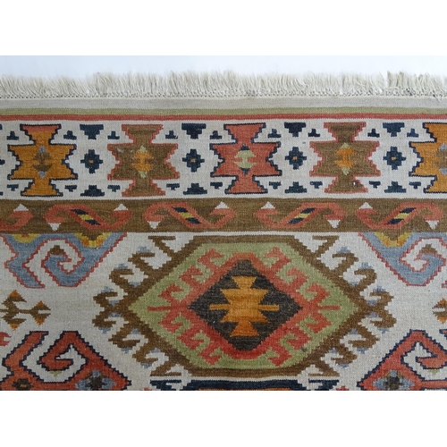 1384 - Carpet / Rug : A rug with cream ground decorated with repeating geometric detail. Approx.  73