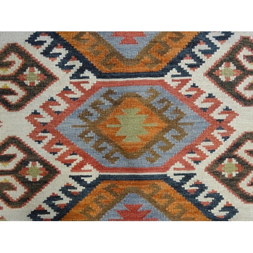 1384 - Carpet / Rug : A rug with cream ground decorated with repeating geometric detail. Approx.  73