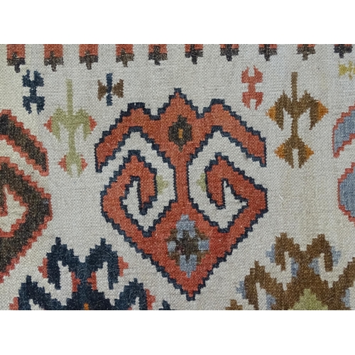 1384 - Carpet / Rug : A rug with cream ground decorated with repeating geometric detail. Approx.  73