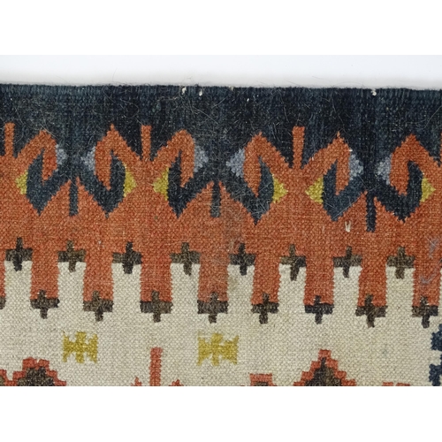 1384 - Carpet / Rug : A rug with cream ground decorated with repeating geometric detail. Approx.  73