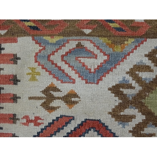 1384 - Carpet / Rug : A rug with cream ground decorated with repeating geometric detail. Approx.  73