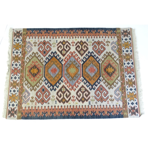 1384 - Carpet / Rug : A rug with cream ground decorated with repeating geometric detail. Approx.  73